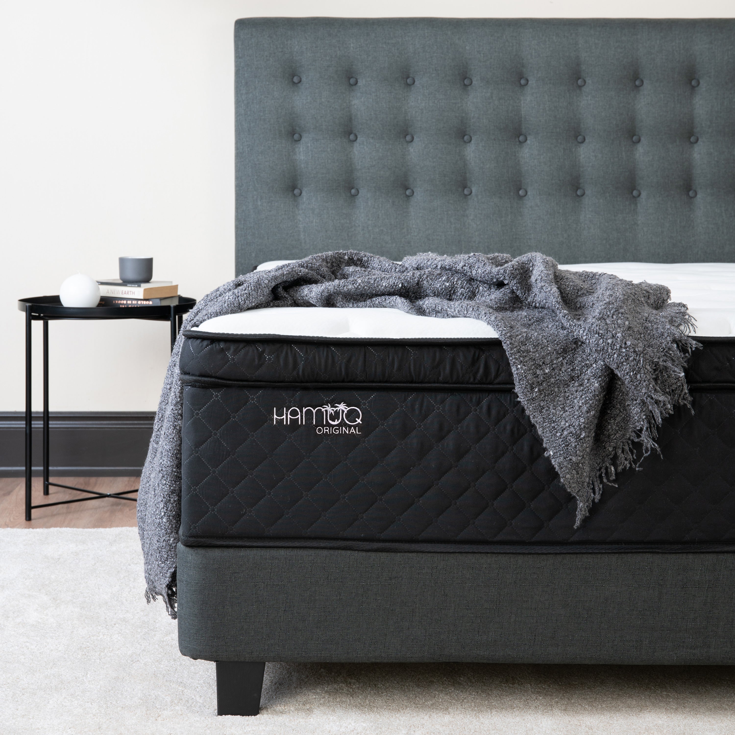 Editorial photo of a Hamuq mattress made up with bedding in a Canadian bedroom